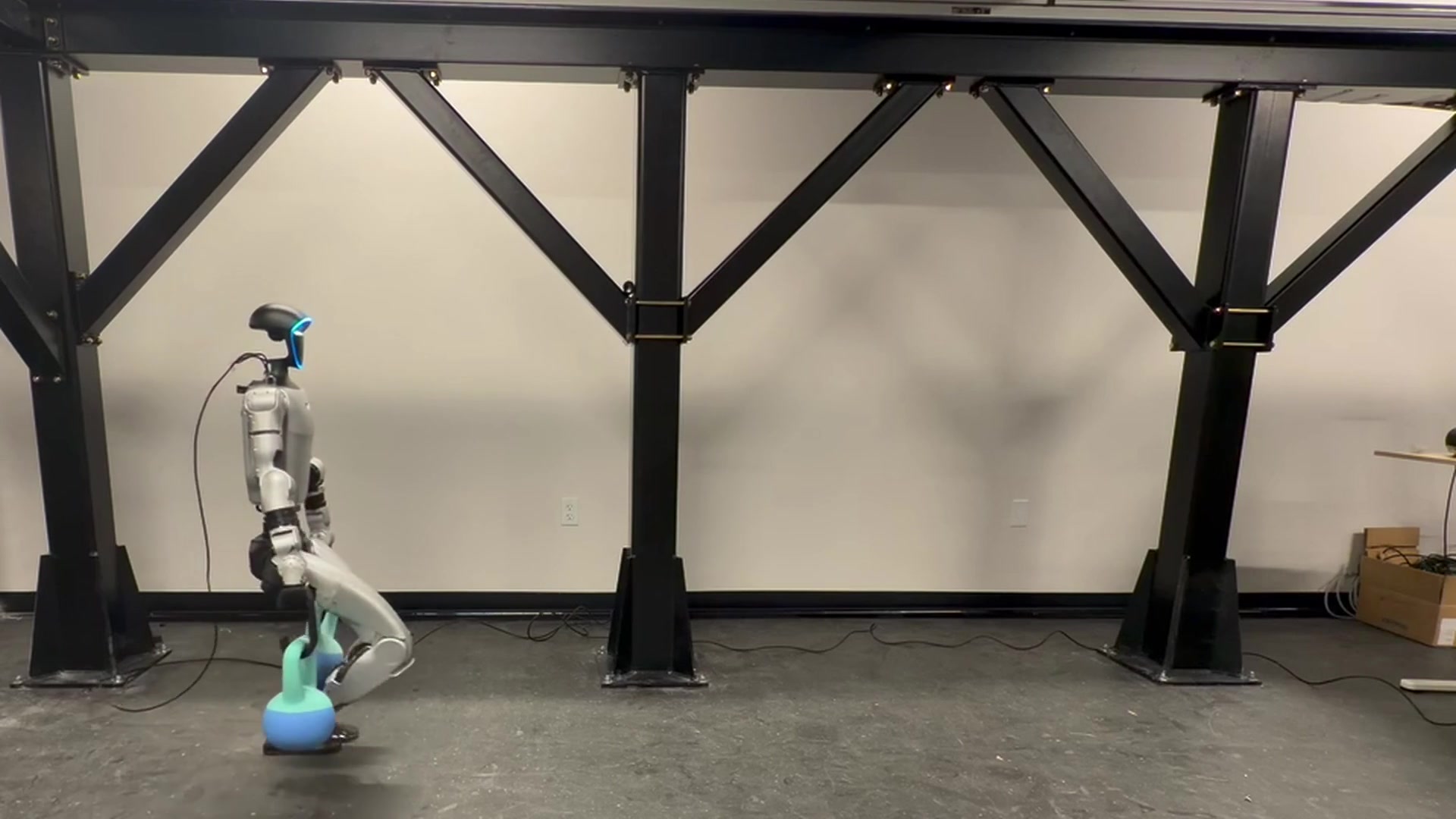 G1 walking while carrying two kettlebells